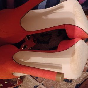 Orange pointy toed suede stilettos
